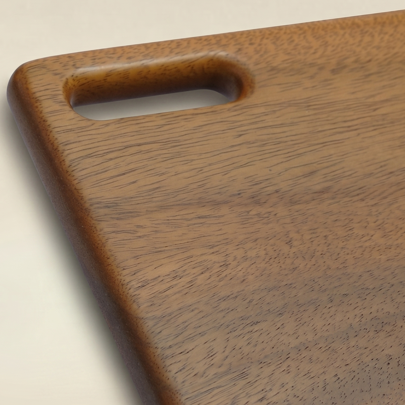Wooden cutting board with a handle on a beige background