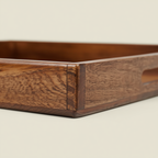 Wooden tray with a handle on a beige background