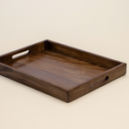 Wooden tray with handles on a beige background